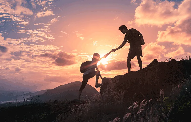 man and woman climbing mountain partner cooperation